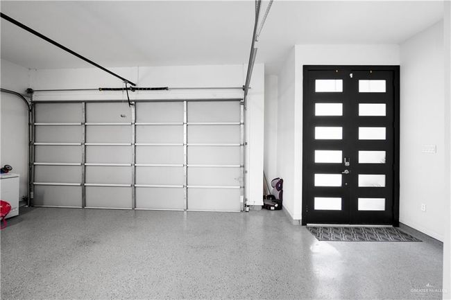 Garage featuring french doors and baseboards | Image 4
