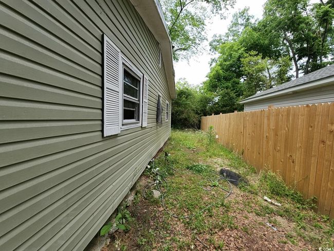 View of home's exterior with fence | Image 4