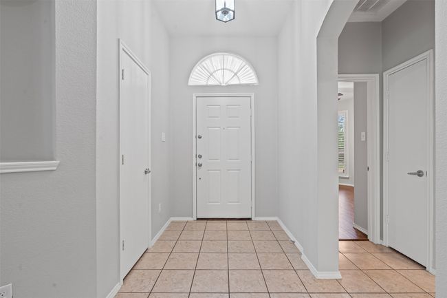 Entryway featuring light tile patterned floors and baseboards | Image 6