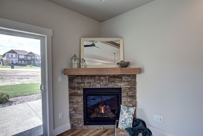 Detailed view of wood finished floors and a fireplace | Image 21