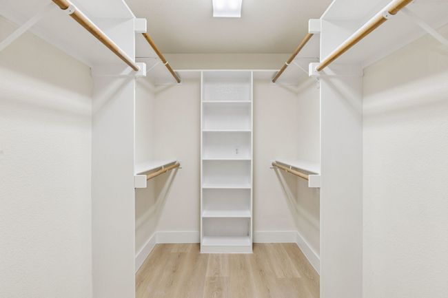 Spacious closet with wood finished floors | Image 20