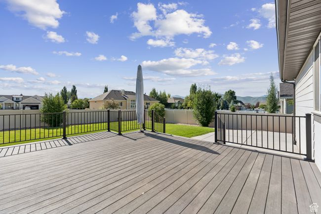 Deck with a residential view and a fenced backyard | Image 33