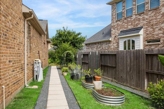 Stone and gravel walkway with a lovely garden area | Image 45