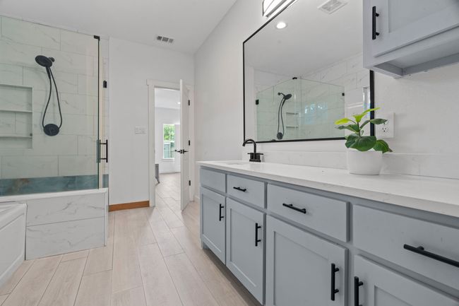 Bathroom featuring a shower stall, vanity, wood finished floors, and recessed lighting | Image 28