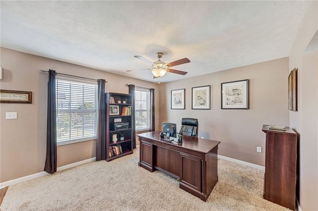 This room is designed as the formal dining room, but is being used as an office. This would also make a great reading room or sitting room. Possibly a homework room? | Image 10