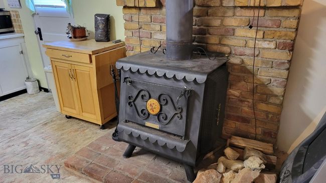 Interior details featuring a wood stove | Image 15