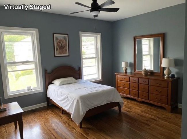 Bedroom featuring multiple windows, dark wood-style flooring, and a ceiling fan | Image 12