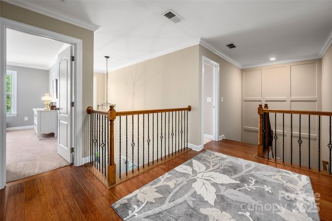 Upper floor with added hardwood stairs and hallway and accent wall | Image 28