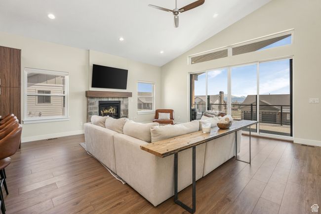 A spacious living room, offering a sense of warmth and elegance. featuring a fireplace, with easy access to a serene balcony. | Image 21