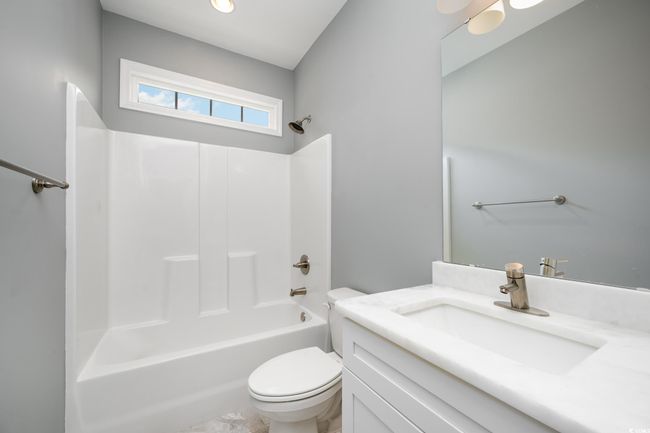 Full bathroom featuring toilet, vanity, and bathing tub / shower​​‌​​​​‌​​‌‌​‌‌​​​‌‌​​‌‌​‌​​​​​‌ combination | Image 13