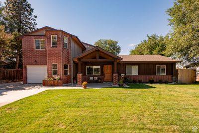 View of front of house with a front yard and a garage | Image 1