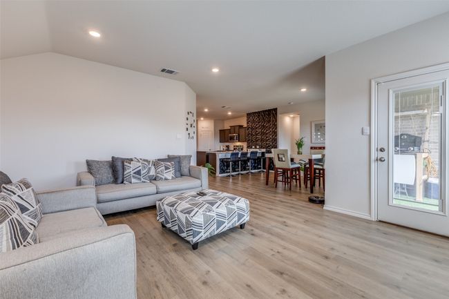 Living area with visible vents, light wood-style flooring, recessed lighting, and vaulted ceiling | Image 10