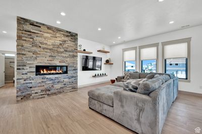 Living room featuring light hardwood / wood-style flooring and a fireplace | Image 3