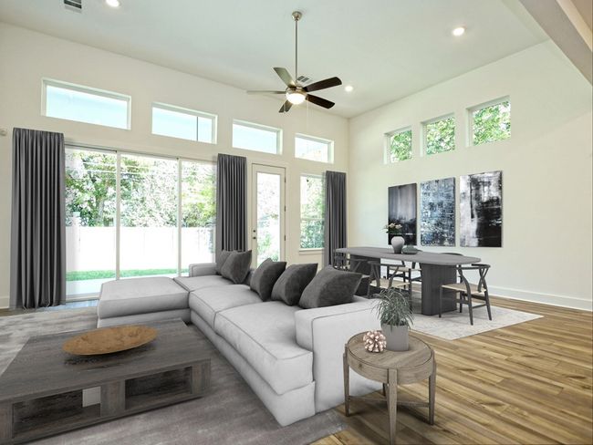 Living area featuring a ceiling fan, recessed lighting, wood finished floors, and a high ceiling | Image 5