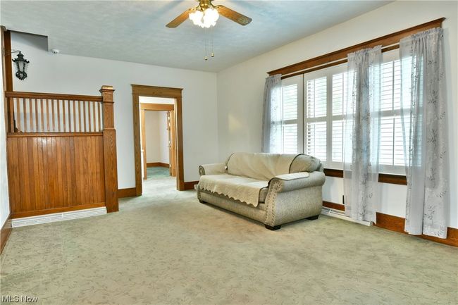 Carpeted living room featuring ceiling fan | Image 14