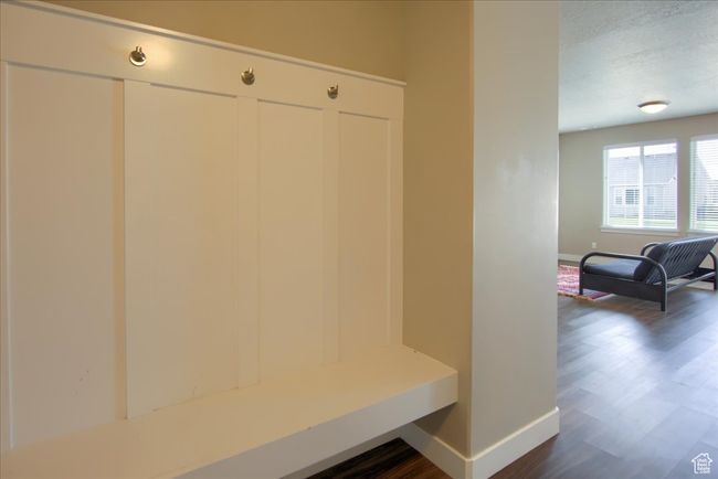 Mudroom with dark wood-type flooring, baseboards, and a textured ceiling | Image 21