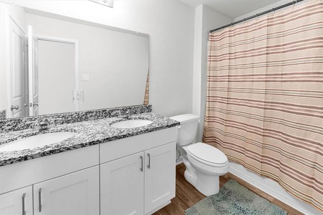 Primary bathroom with large vanity and double sinks. | Image 32