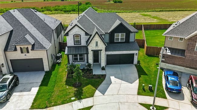French country style house featuring driveway, a rural view, a shingled roof, and agricultural plots | Image 33