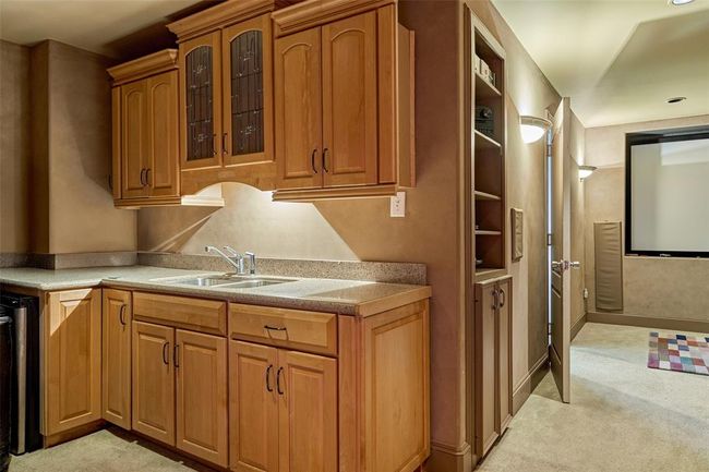 Luxurious wet bar in the movie room, featuring custom cabinetry and ample counter space. | Image 25