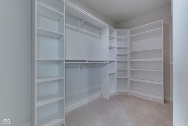 Check out this Master Closet. You could get lost in here. Custom shelving allows so much organization | Image 28