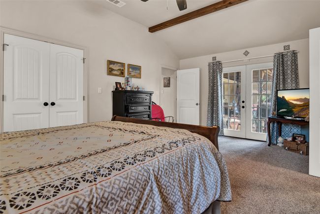 A large closet is on the left and the double doors lead to the back patio gathering area. | Image 19