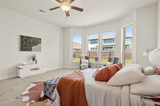 Carpeted bedroom with visible vents, baseboards, and ceiling fan | Image 15