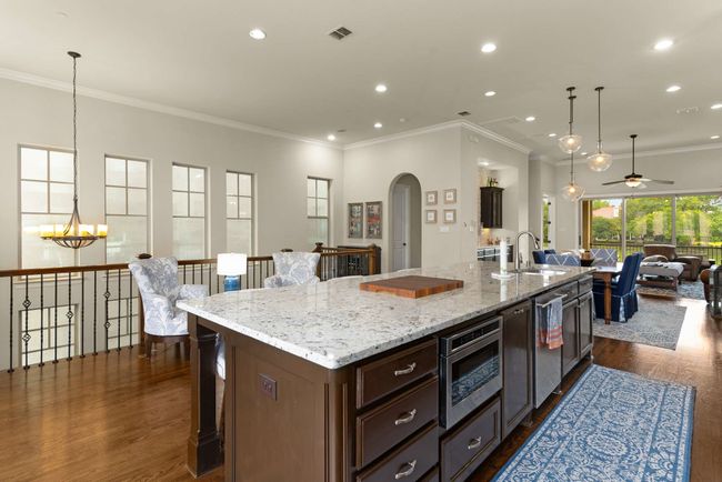 Kitchen with open floor plan, walk in pantry 1/2 bath, dry bar and sitting area. | Image 7