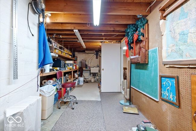 unfinished below grade area featuring a workshop area and a sink | Image 34