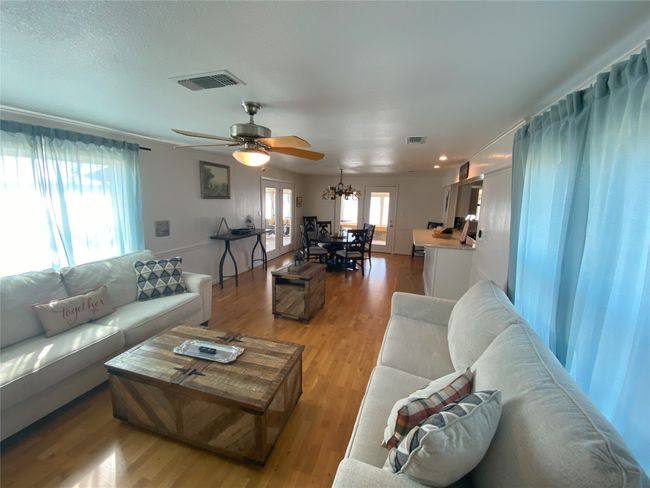 Living area looking toward dining area. Living room has a fireplace | Image 8