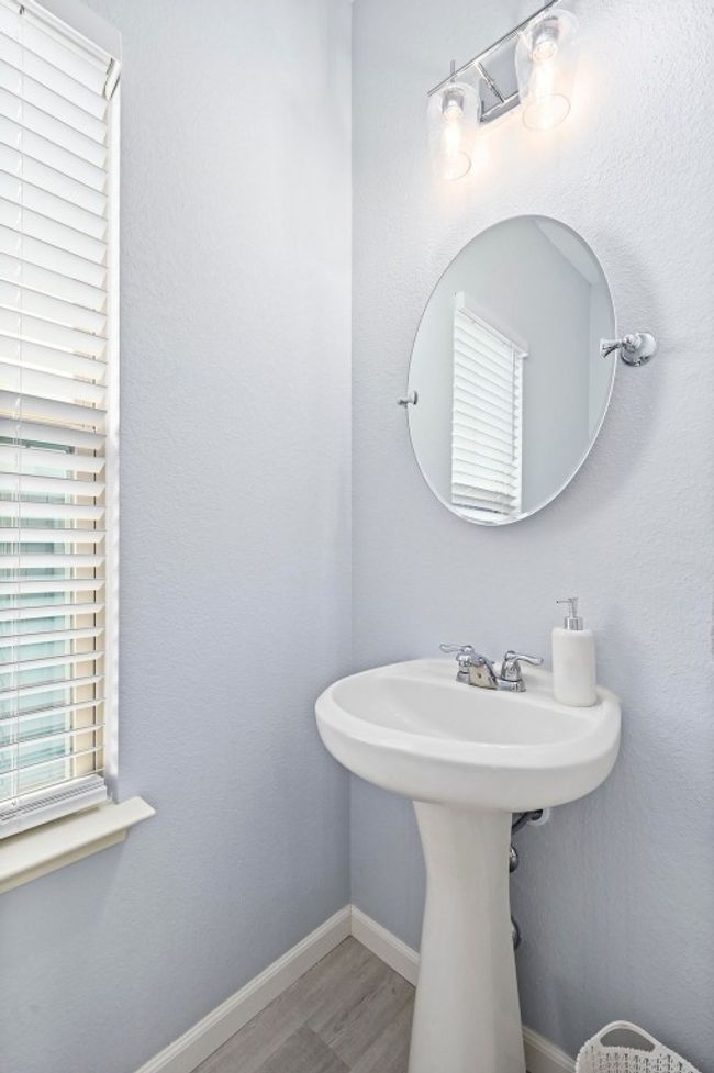 Bathroom with wood finished floors, a healthy amount of sunlight, and baseboards | Image 22