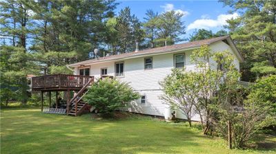 Rear view of property with a lawn and a wooden deck | Image 3