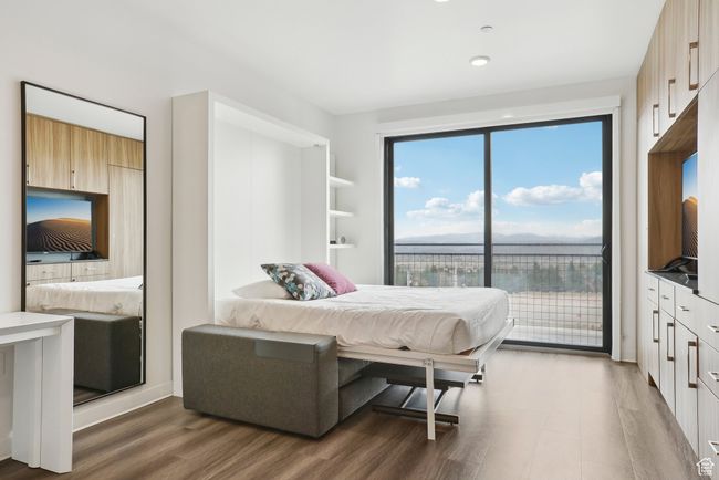 Bedroom with access to exterior and wood finished floors | Image 15