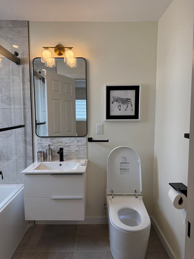 Full bath with tile patterned flooring, vanity, shower / bathtub combination, and backsplash | Image 19