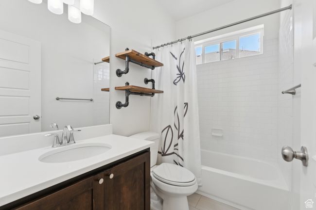 Full bathroom with vanity, shower / bath combo, and tile patterned flooring | Image 19