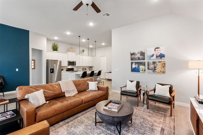 Living area with a ceiling fan, light wood finished floors, and recessed lighting | Image 9