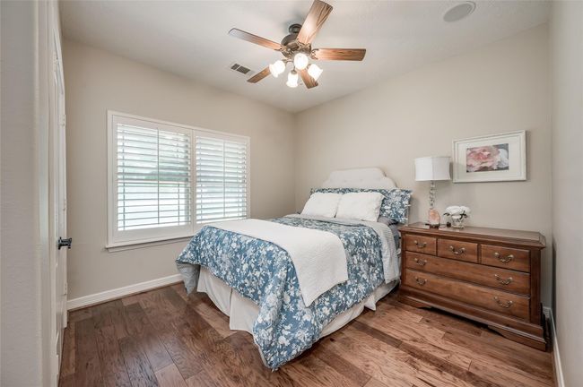 This spacious front bedroom comfortably fits a queen-sized bed with extra room. | Image 17