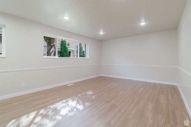 Empty room featuring wood finished floors, baseboards, and recessed lighting | Image 5