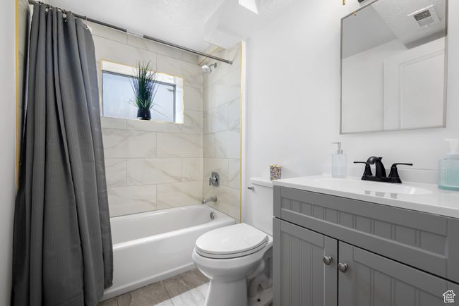 Bathroom featuring shower / bathtub combination with curtain and vanity | Image 14