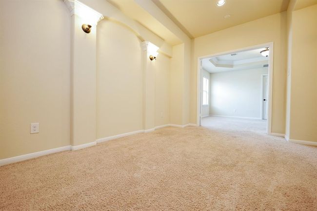 Golden tones in the cinema space open onto naturally lit areas on the 'game room' floor. | Image 19