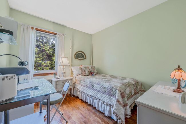 Bedroom with wood finished floors and a desk | Image 17