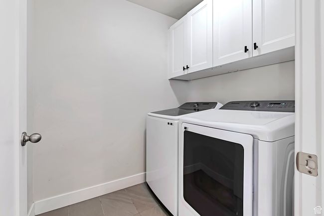 Washroom with washing machine and dryer, cabinet space, and baseboards | Image 19
