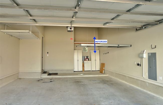 20'x25'x13' Garage. The ceiling height provides room for additional storage with one of the three racks being motorized (lower to floor level). | Image 27