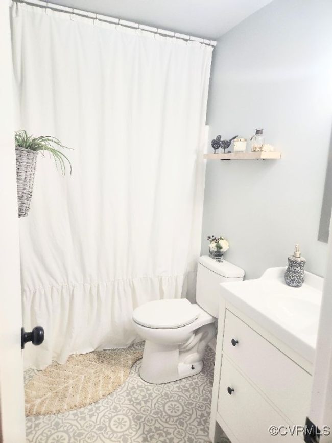 Bathroom featuring vanity, tile patterned flooring, and curtained shower | Image 12