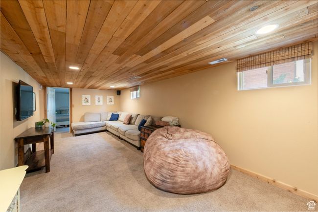 Living room featuring carpet flooring, wooden ceiling, healthy amount of natural light, and recessed lighting | Image 17