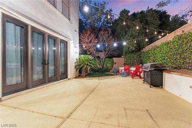 Patio space with double french doors into the primary bedroom. | Image 20