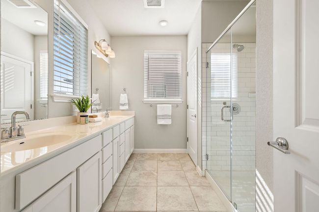Full bath featuring double vanity, double sinks, and a stall shower | Image 18
