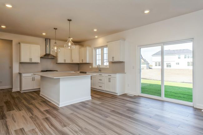 Photo is of the actual home. Soaked in natural sunlight, the homes eat-in dining room has ample space for a dining table located in the heart of the home. | Image 4
