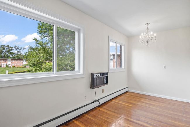 Possible Bedroom Area with Hardwood Floors and Large Windows | Image 7