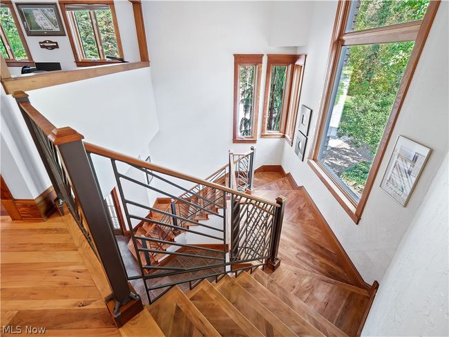 Staircase featuring a high ceiling and parquet flooring | Image 16