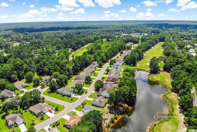 Aerial view of residential area featuring a large body of water and a local golf course | Image 33
